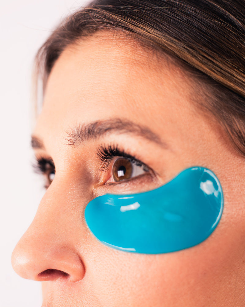 Close-up of a woman wearing blue Eye Bright Masks under her eye highlighting hydration and brightening effect gallery position 1