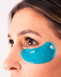 Close-up of a woman wearing blue Eye Bright Masks under her eye highlighting hydration and brightening effect gallery position 1