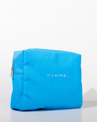 Bright blue MDAiRE cosmetic bag featured in the Glow on the Go Bundle shown in gallery position 1