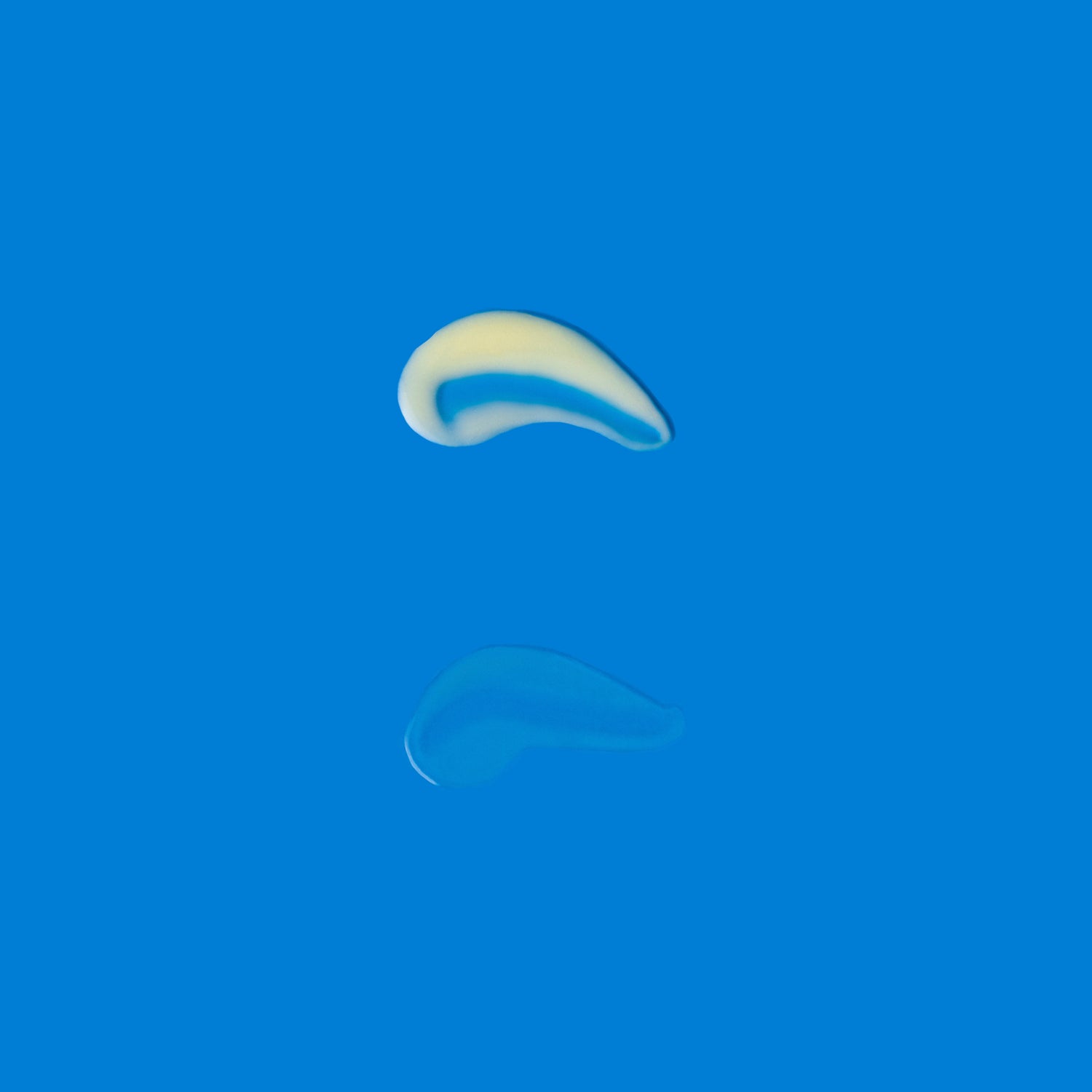 Smooth cream texture of Correct and Protect Duo shown with glossy reflection on bright blue background gallery position 1